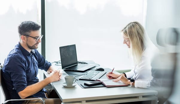 Business meeting. Client consulting. Confident business woman, real estate agent, financial advisor explaining details of project or financial product to client in office