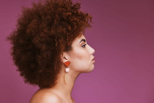 Model, profile or afro hairstyle on isolated purple background in empowerment, curly maintenance or skincare salon promotion. Beauty woman, natural or hair growth texture on cosmetics studio mock up.