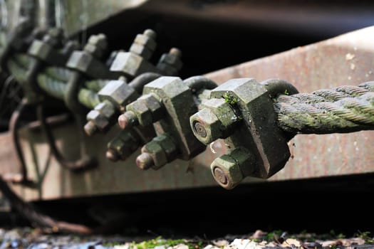 An abandoned old railway carriage with rusty metal cable macro