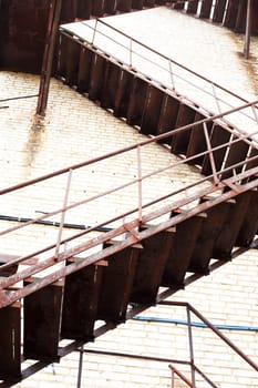 Industrial background. Closeup of high brick wall of old factory with fire escape