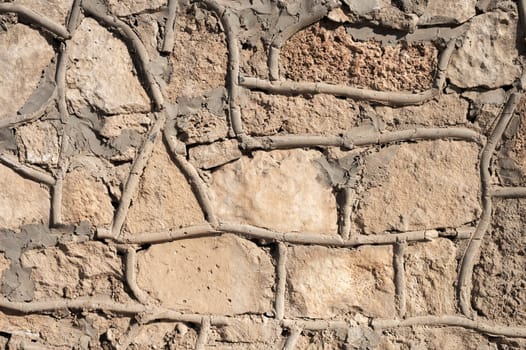 The old natural stone masonry is absurdly finished with modern cement. An example of poor design and inept finishing of the gable of a house.