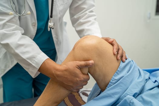 Asian elderly woman patient show her scars surgical total knee joint replacement Suture wound surgery arthroplasty on bed in hospital, healthy strong medical concept.