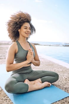 Yoga, zen and wellness, black woman at the beach for fitness and meditation, mindfulness and peace with exercise outdoor. Workout, stress relief and happy with body training and healthy active life