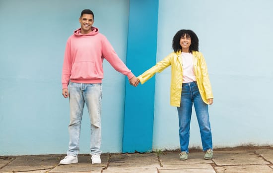 Happy couple, love portrait and holding hands together for support care, relationship and bonding in urban town. Man, woman smile and partnership hand, romance and solidarity or compassion lifestyle.