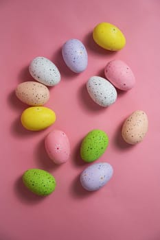 Painted quail eggs on a pink background. Easter decorations