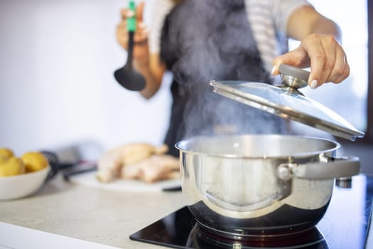 Young woman is cooking in the kitchen. Healthy eating. Healthy lifestyle. Cook at home. Cooking food.