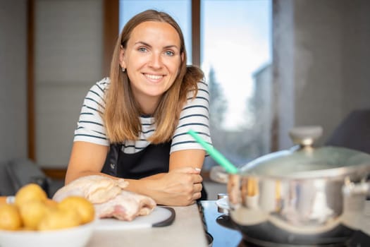 Young woman is cooking in the kitchen. Healthy eating. Healthy lifestyle. Cook at home. Cooking food.