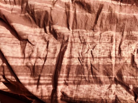 Abstract background and texture of crumpled brown fabric. Texture, pattern, frame and copy space