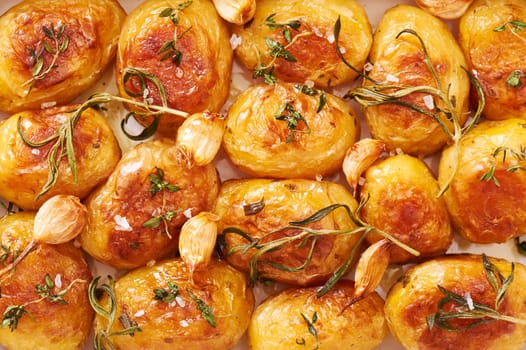 Roasted potatoes with garlic, thyme and rosemary close-up