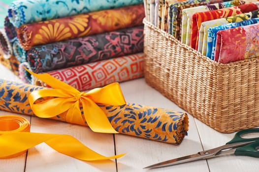 Batik kits turned into rolls tied with a decorative bow