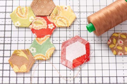 English paper pieced hexagons on white craft mat