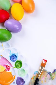 Design concept - Preparing for Easter celebration, painting Easter eggs with colorful Acrylic pigment color dyestuff in palette, top view, lifestyle.