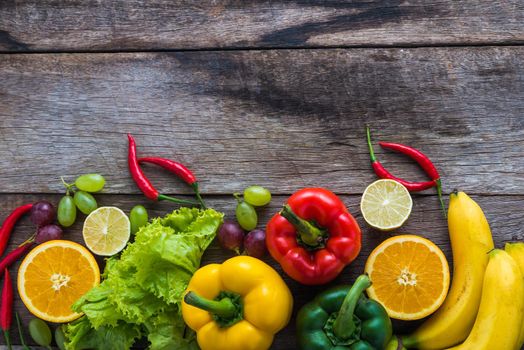 fresh vegetables and fruits for fitness dinner on wooden background top view, food concept