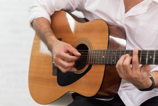 man playing guitar on white background