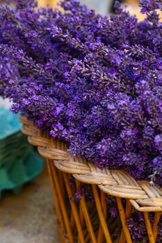 Close up fresh purple lavender flowers in wooden basket on retail display in Provence, France