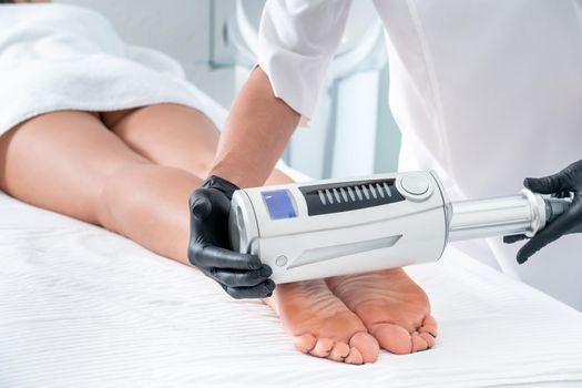 Partial view of cosmetologist in rubber gloves doing endospheres therapy
