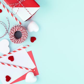 Valentine's Day, Mother's day art design concept for promotion - Red, white wrapped gift box isolated on pastel light blue color background, flat lay, top view.