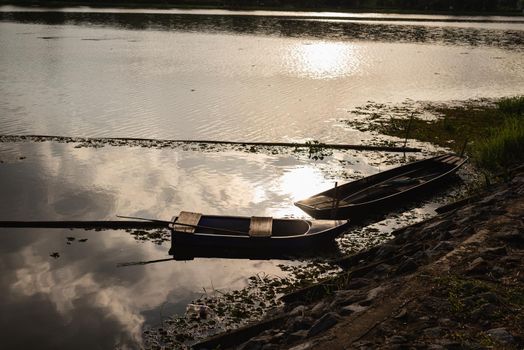 wooden boat parking on the side of the river