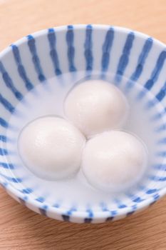 Tang yuan, tangyuan, yuanxiao in a small bowl. Delicious asian traditional festive food rice dumpling balls with stuffed fillings for Chinese Lantern Festival, close up.