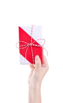 Asian woman holding, giving, sending a wrapped packaged gift box with tied bow-knot isolated on white background, clipping path, cut out, close up.