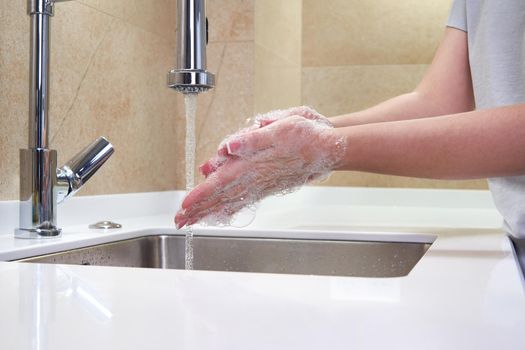 Woman washing hands with antibacterial soap for corona virus prevention, hygiene to stop spreading coronavirus covid19