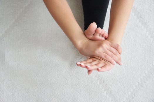 Yoga paschimottanasana forward bend pose by young woman. Young yogi practice yoga poses relaxing in studio