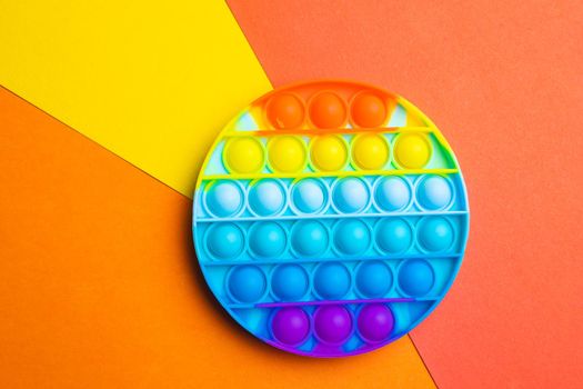 Pop it anti-stress on a colored background. Modern toys. Toys for children. Silicone game. Autism. Trend. Copy space