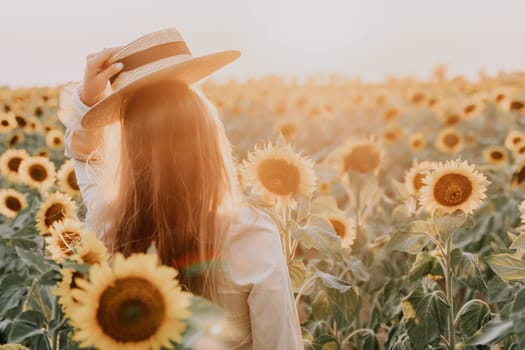 Woman in the sunflowers field. Summer time. Young beautiful woman standing in sunflower field.