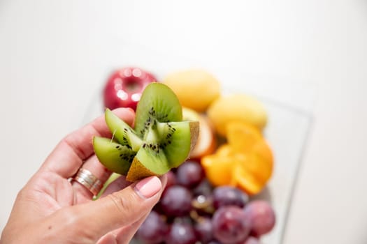Healthy fruit platter, strawberries raspberries oranges plums apples kiwis grapes blueberries