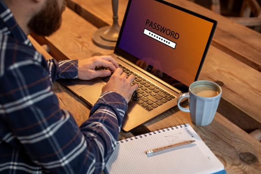 Cropped image of a young man working on his laptop in a coffee shop, rear view of business man hands busy using laptop at office desk, young male student enters a password on computer sitting at wooden table.