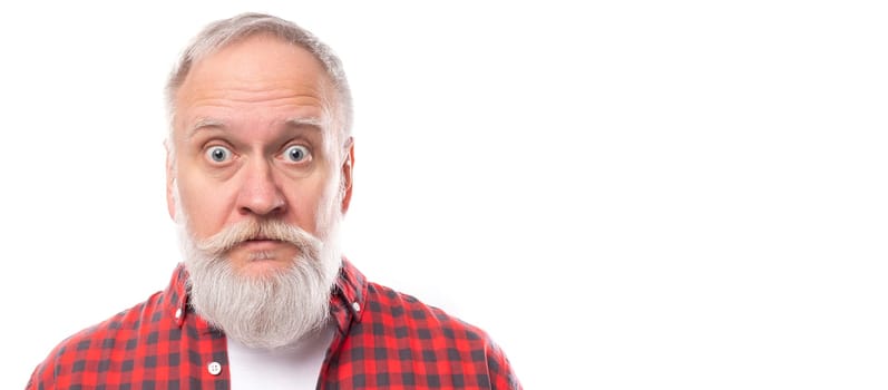 surprised mature gray-haired man with a beard and mustache with wide open eyes on a white background with copy space.