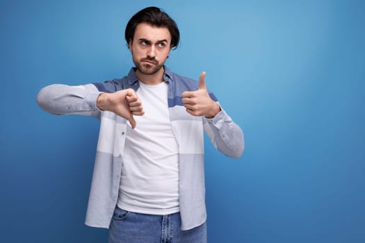 serious brutal brunette man in informal style.