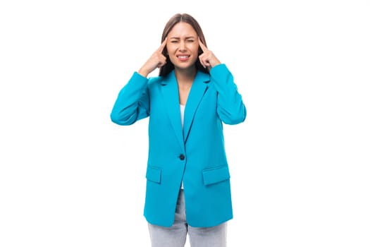 young indignant upset brunette secretary woman in a blue elegant jacket is worried on a white background with copy space.