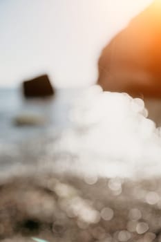 Abstract nature summer or spring ocean sea background. Small waves on water surface in motion blur with bokeh lights from sunrise.