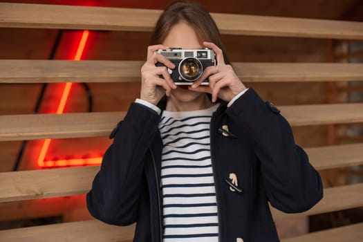 Lifestyle portrait of young stylish woman walking on street, with camera, smiling enjoy weekends, make a photo of her travel, old retro photocamera, vintage