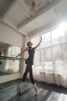 A beautiful Asian ballerina is training in a dance class. Vertical photo