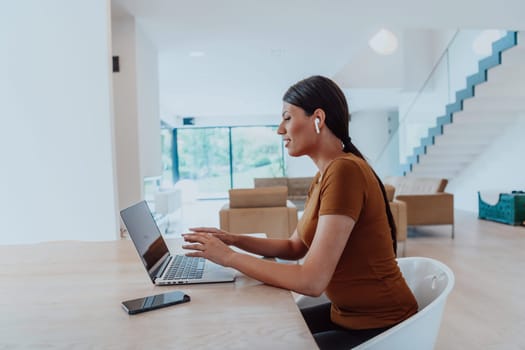 Woman sitting in living room using laptop looking at cam talk by video call with business friend relatives, head shot. Job interview answering questions