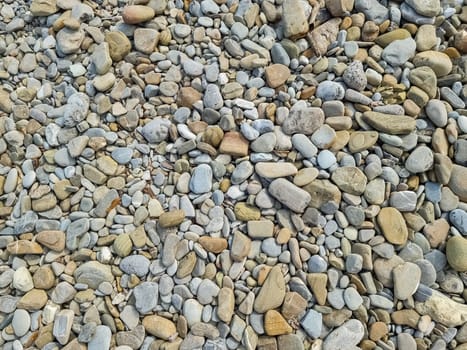 Small round stones background. Stone texture. Rough surface of small pebble stone.