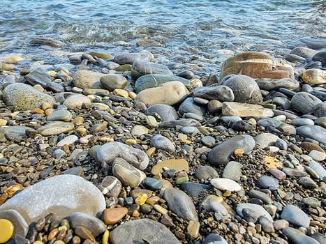 Stones on beach and sea water