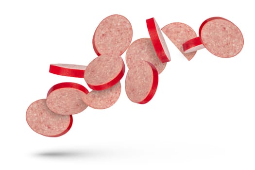 Flying sausage. Slices of salami sausage on a white isolated background. Slices of sausage scatter in different directions and fall casting a shadow. To be inserted into a design or project