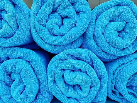 Stack of rolled towels in hotel near beach