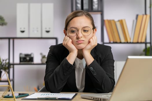 Tired Caucasian business woman feeling worried about financial problem, stress at home office workplace. Freelancer broker girl frustrated thinking of money debt, budget loss, bankruptcy. Overworking