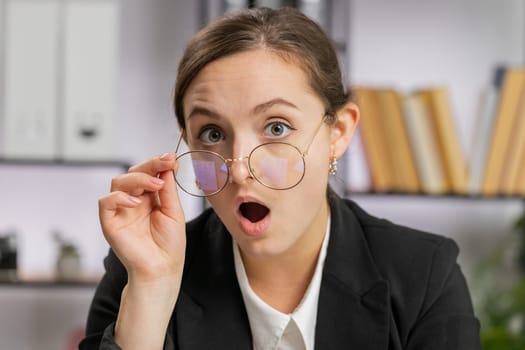 Oh my God, Wow. Caucasian business woman working at office workplace, looking at camera shocked by sudden victory game winning, lottery goal achievemen, good news. Professional manager freelancer girl