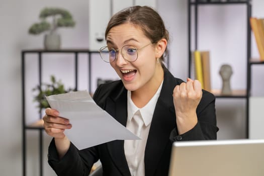 Caucasian business woman open envelope letter reading it. Career growth advance promotion bank loan approve, successful admission to monetary award, long-awaited invitation great news lottery game win