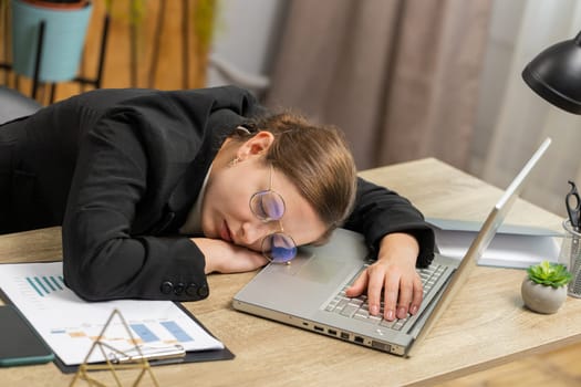Bored sleepy Caucasian business woman in glasses worker working on laptop computer leaning on hand falling asleep at office. Exhausted tired freelancer workaholic girl. Employment occupation, workless