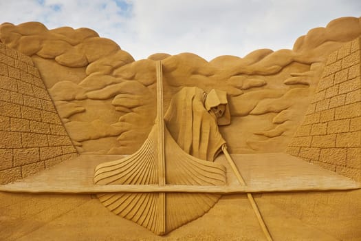 Sondervig, Denmark, May 21, 2023: International Sand Sculpture Festival. Charon is the carrier of the souls of the dead