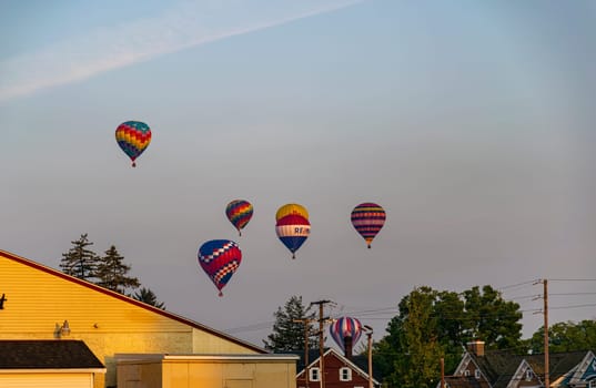 Bird in Hand, Pennsylvania, September 17, 2022 - A View of Multiple Multi Colored Hot Air Balloons Floating in a Beautiful Morning Blue Sky With Thin Clouds