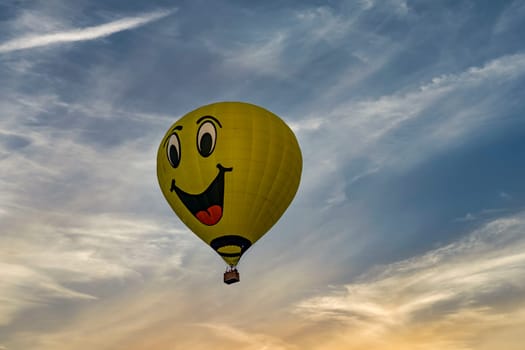 Bird in Hand, Pennsylvania, September 18, 2023 - A View of a Hot Air Balloon With a Happy Face on it Floating in a Blue Sky With Thin Clouds
