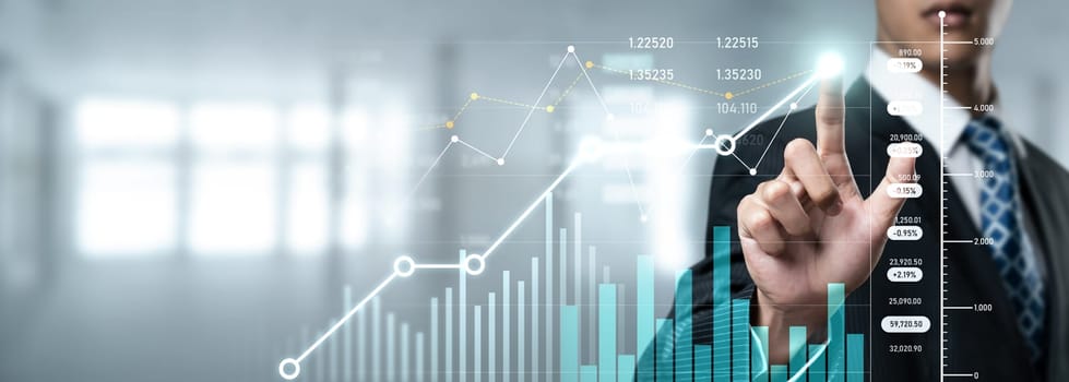 Businessman analyst working with digital finance business data graph showing technology of investment strategy for perceptive financial business decision. Digital economic analysis technology concept.