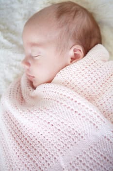 Baby, closeup and sleeping on bed, blanket and tired in profile in family home for growth, peace and comfort. Newborn infant girl, exhausted and childhood development in nursery, bedroom and house.